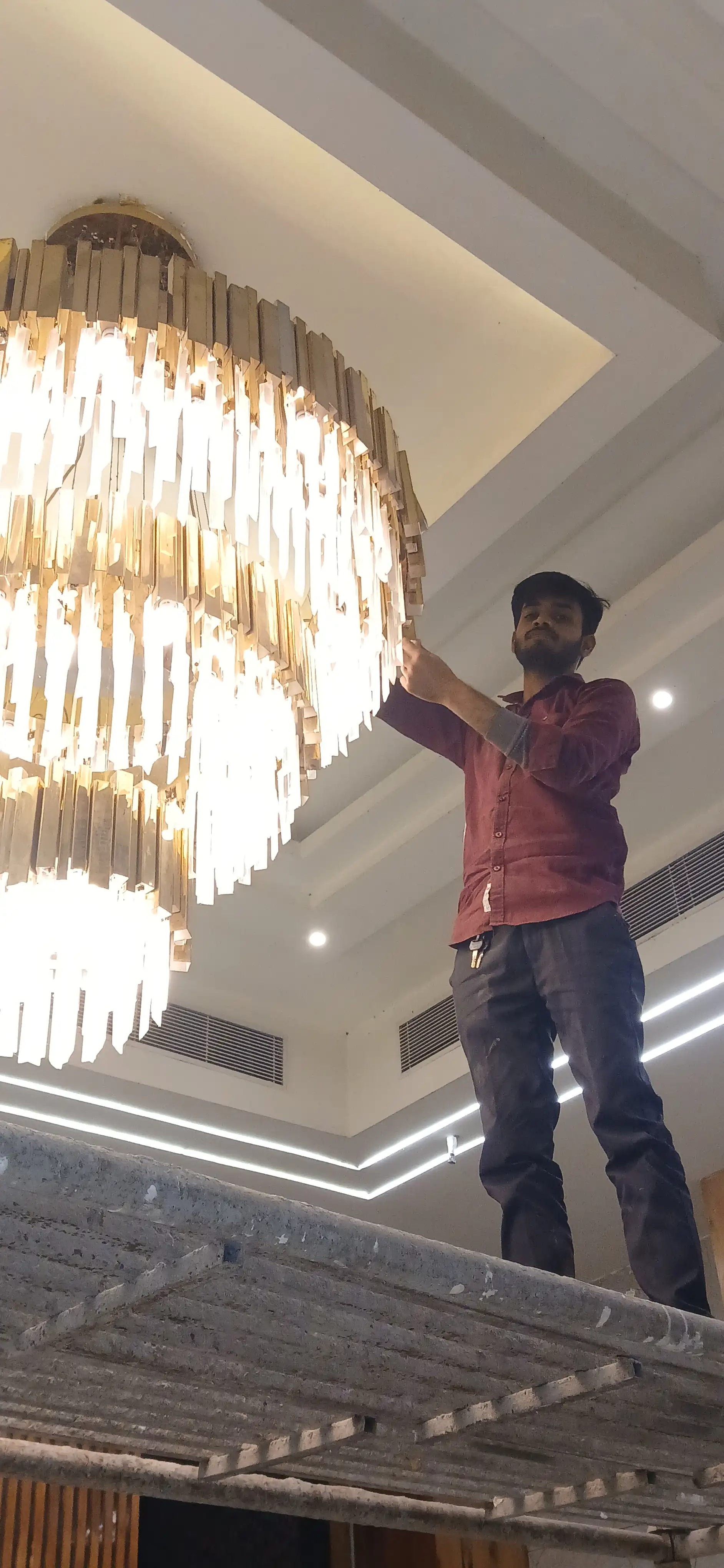 Professional large chandelier installation service for banquet hall and luxury venue in India