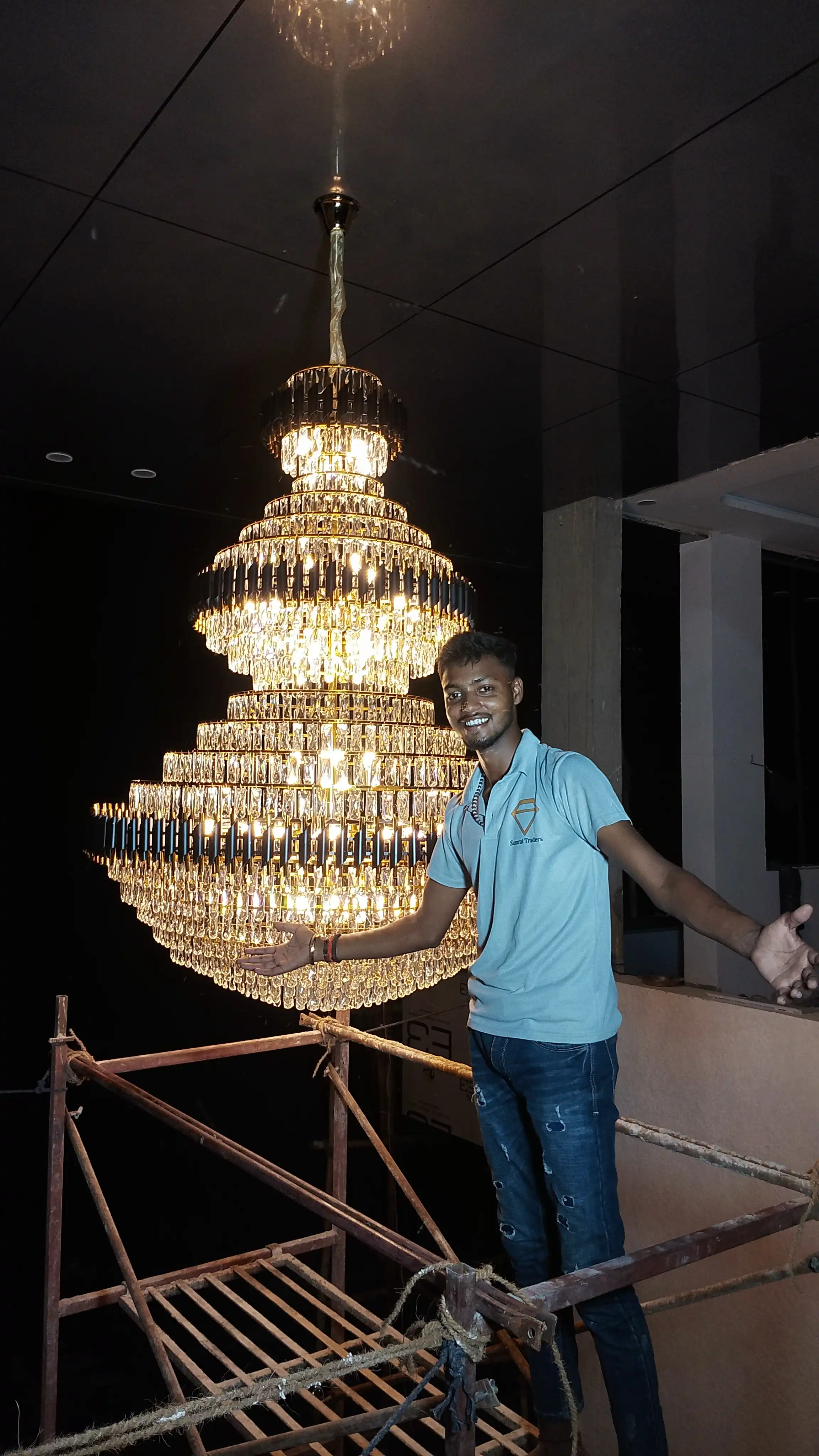 Illuminated Black Mamba luxury crystal chandelier with multiple tiered rings and golden crystal detailing
