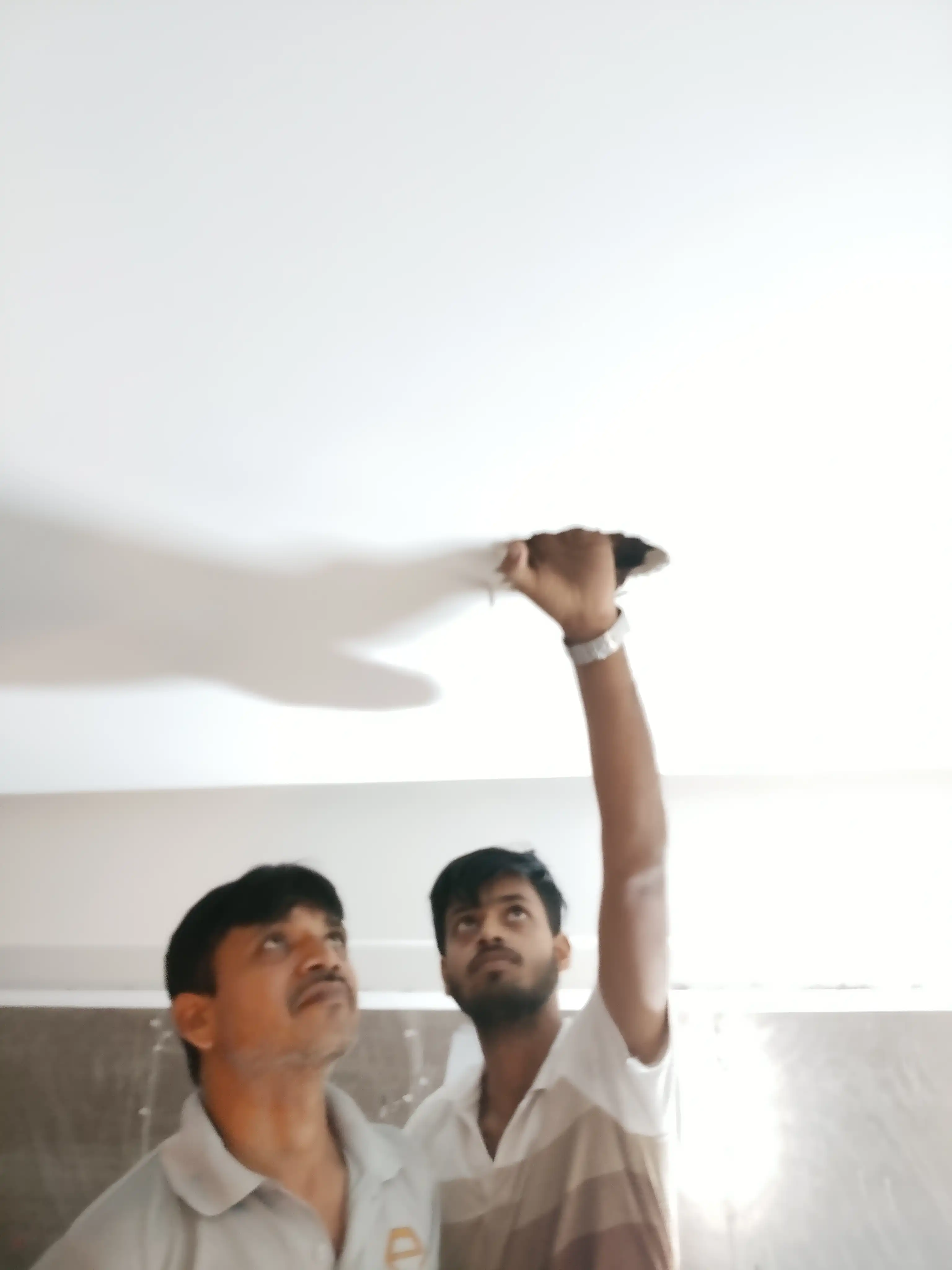 Samrat Traders team inspecting ceiling and chandelier installation requirements at a project site