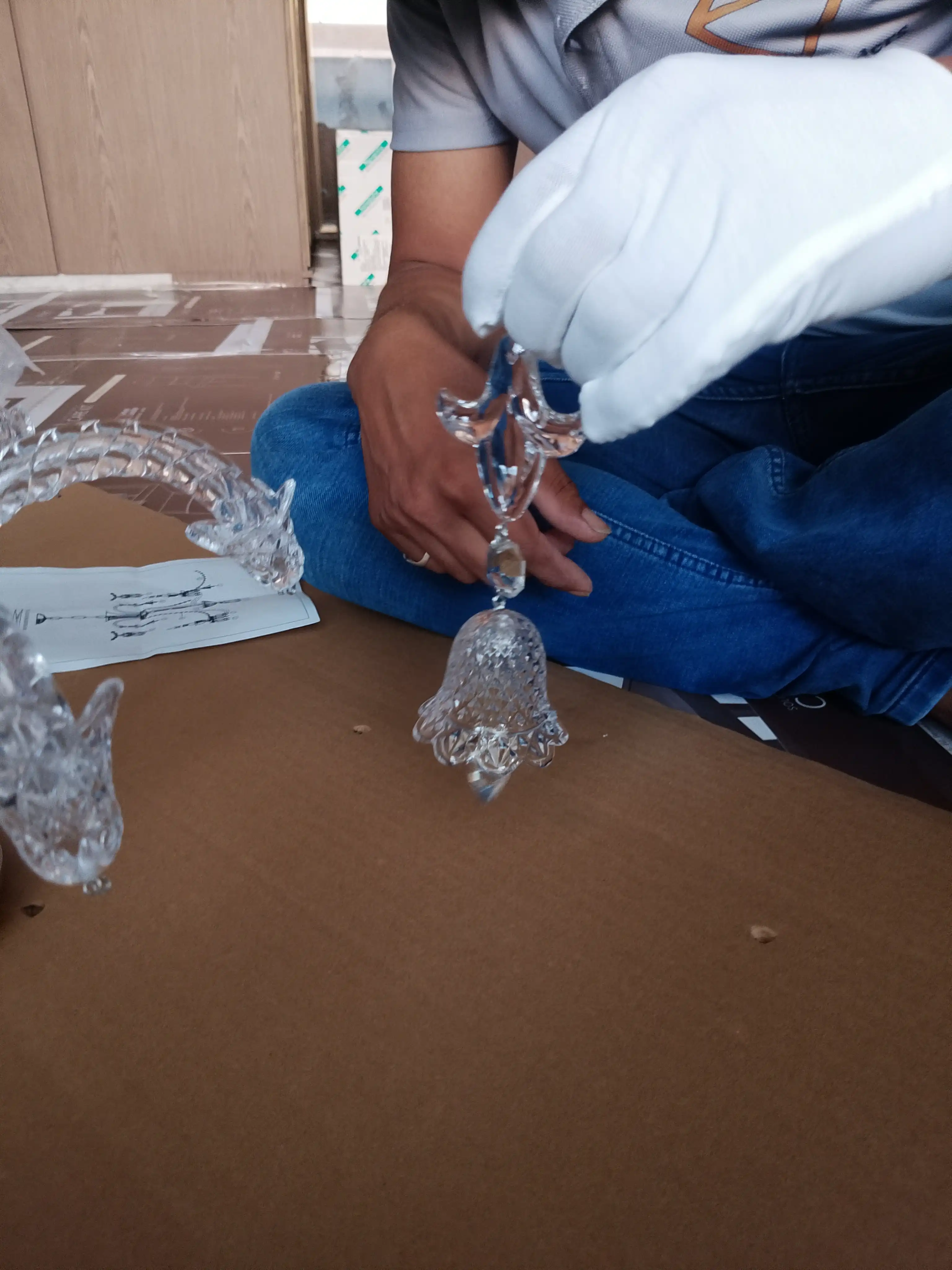 Samrat Traders technician assembling decorative crystal chandelier elements