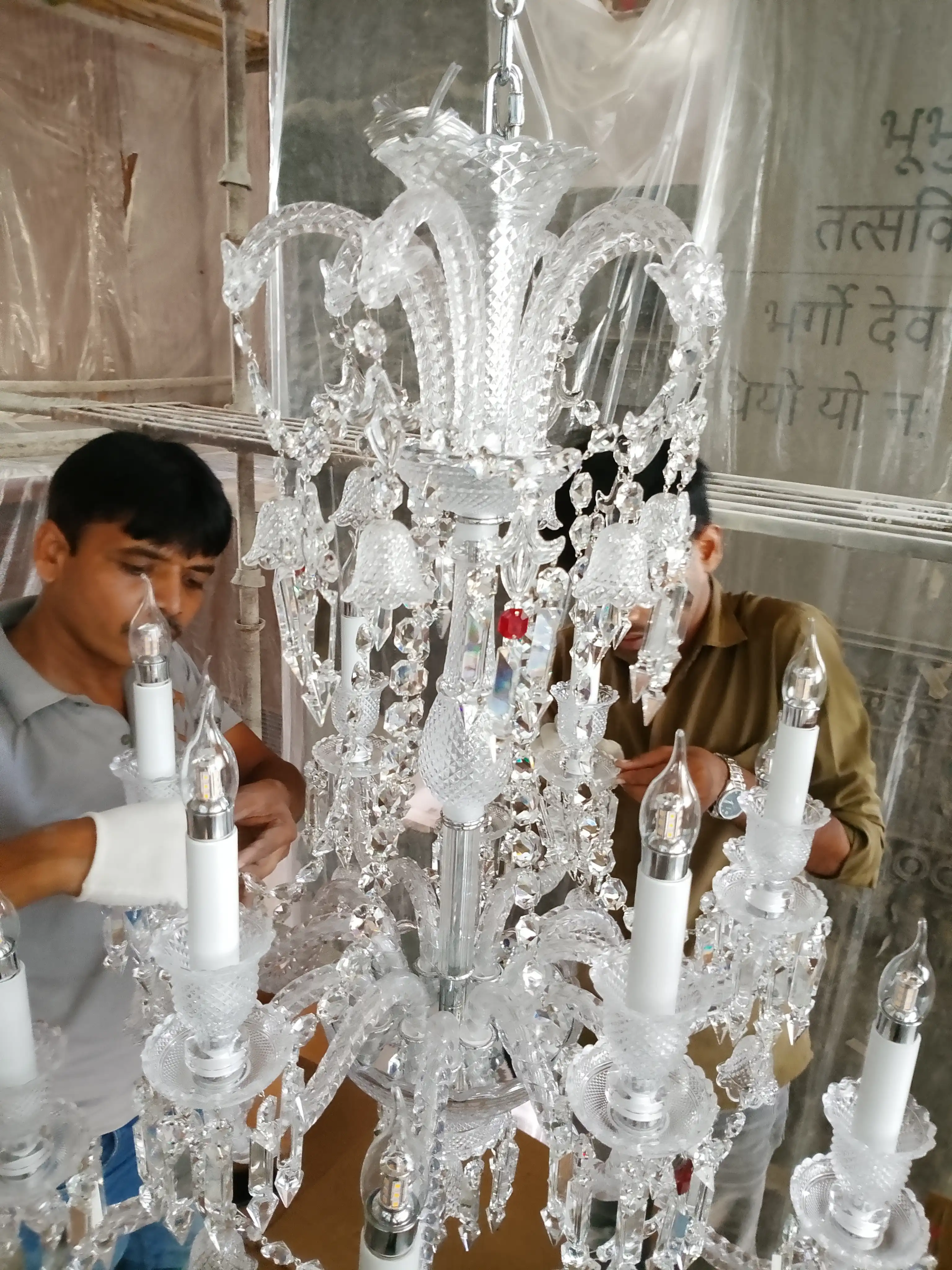 China imported crystal chandelier being assembled by professional chandelier installation technicians